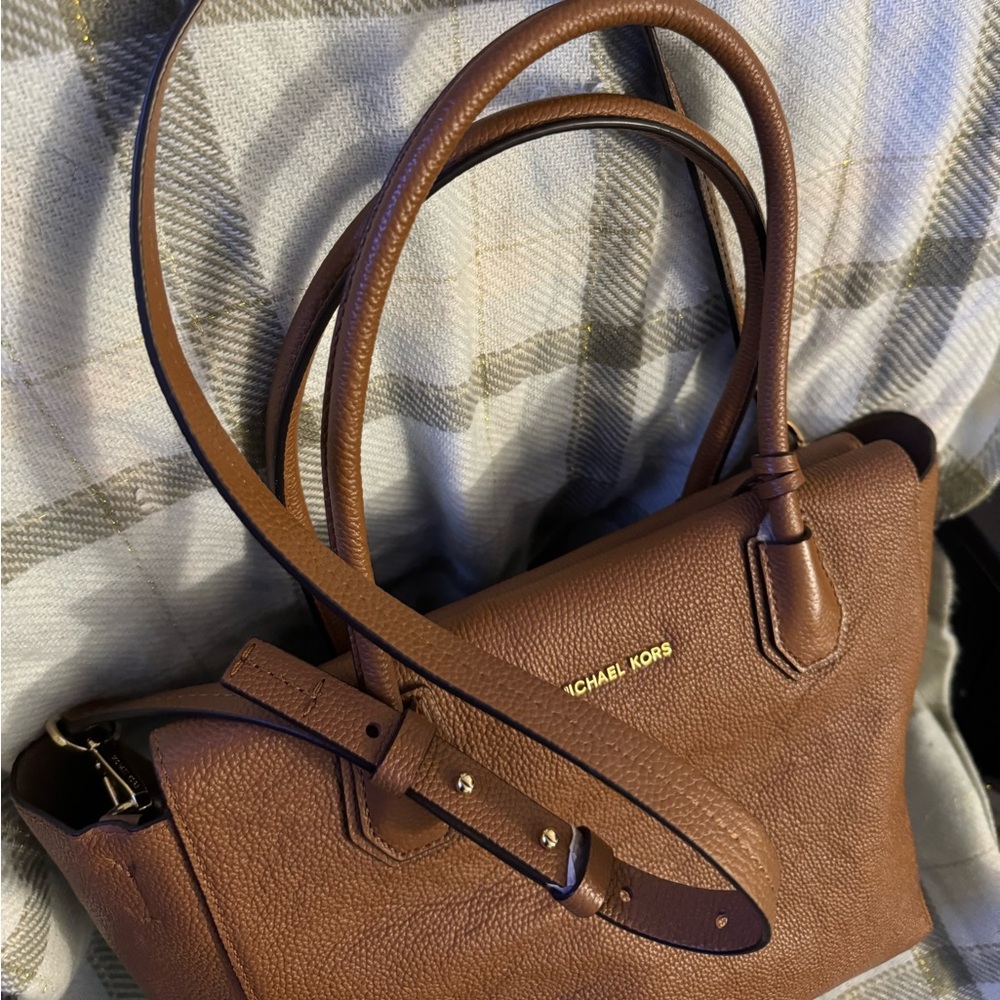 I am selling a Michael Kors bag and it is used but still in good condition.